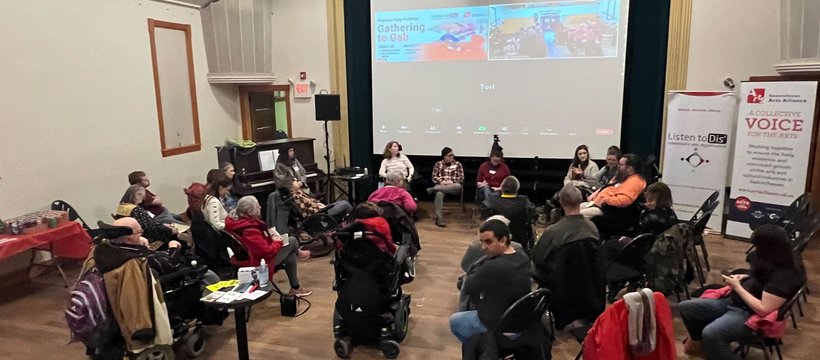 A photo of people gathered in an event room for a Pajama Party Politics event.