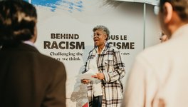 A photo of participants and facilitators in the Behind the Racism: Challenging the Way We Think exhibition.