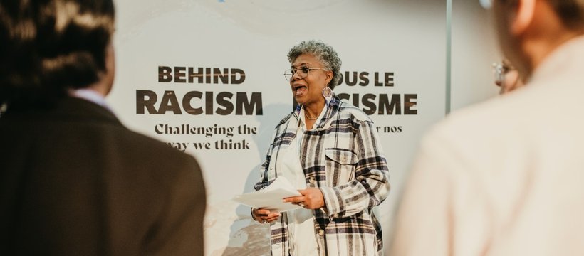 A photo of participants and facilitators in the Behind the Racism: Challenging the Way We Think exhibition.