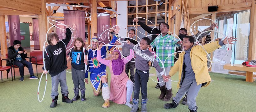 A photo of a Indigenous-Immigrants Heritage learning event, where newcomer youth learned about Indigenous traditional dances during an excursion to Wanuskewin Heritage Park.