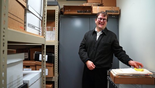 Image of archivist Quinn Bell in the archive room.