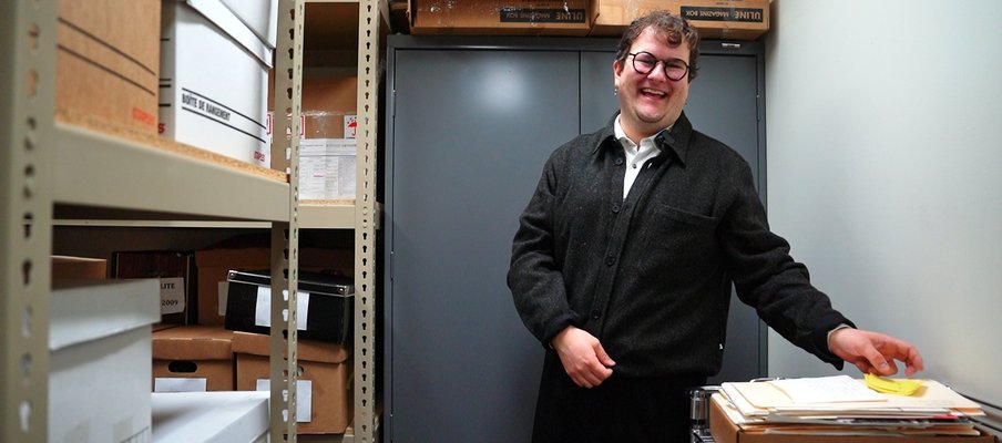Image of archivist Quinn Bell in the archive room.
