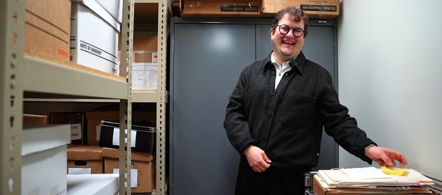 Image of archivist Quinn Bell in the archive room.