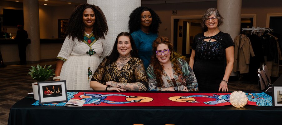 A photo of MCoS staff at their 50th anniversary gala in 2025, including: Yordanos Tesfamariam, Kelsey Aitcheson, Titilayo Omolola, Ali Thompson, Rhonda Rosenberg.