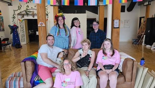 Image of a group of Kaleidoscope camp organizers sitting on a couch smiling.