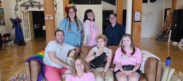 Image of a group of Kaleidoscope camp organizers sitting on a couch smiling.