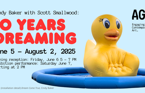 In the image is a huge, inflated yellow duck chair that looks like a giant rubber ducky beach toy.