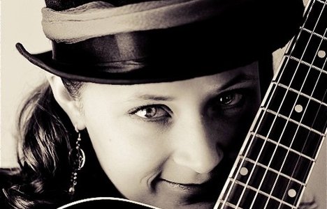 Image of lady with a guitar.