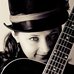 Image of lady with a guitar.
