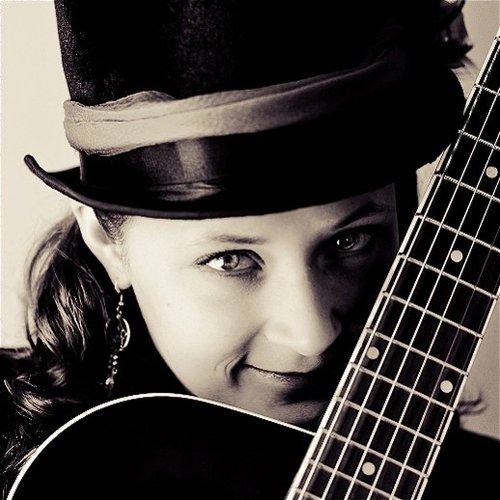Image of lady with a guitar.
