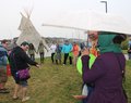 Community join hands for round dance