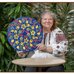 Artist Dawna Hawrysh holds one of her Petrykivka paintings.