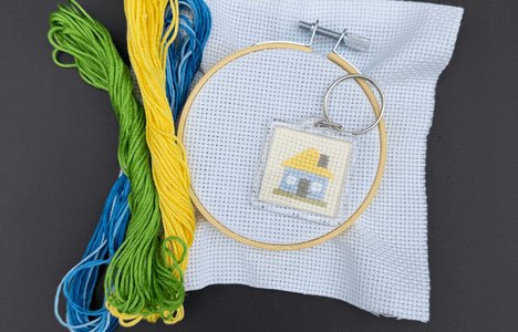 An image of embroidered keychain (Ukrainian house) with materials