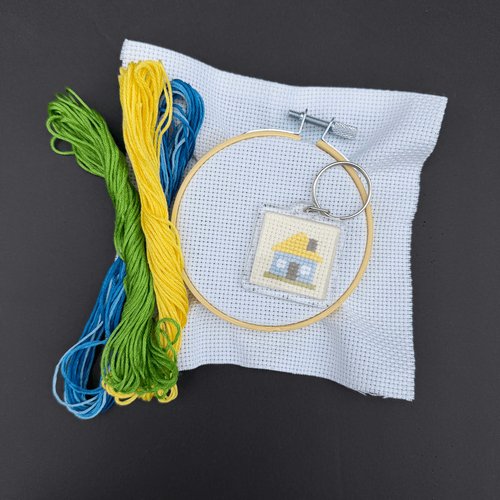 An image of embroidered keychain (Ukrainian house) with materials