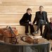 Standing at a concert grand: pianist Jamie Parker; Annalee Patipatanakoon, holding her violin' and Roman Borys, holding his cello.
