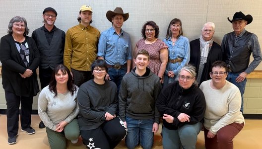 A group of young Spark program participants posing with performers from an event they helped organize.