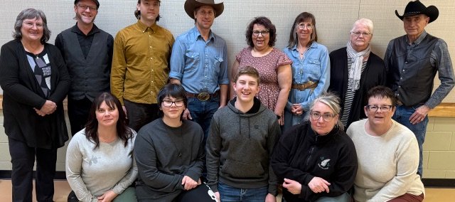 A group of young Spark program participants posing with performers from an event they helped organize.