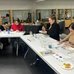 An image of participants sitting at the table and painting at one of Petrykivka & Wine Nights