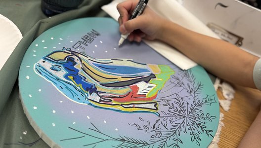 Photo of child painting a colourful art piece