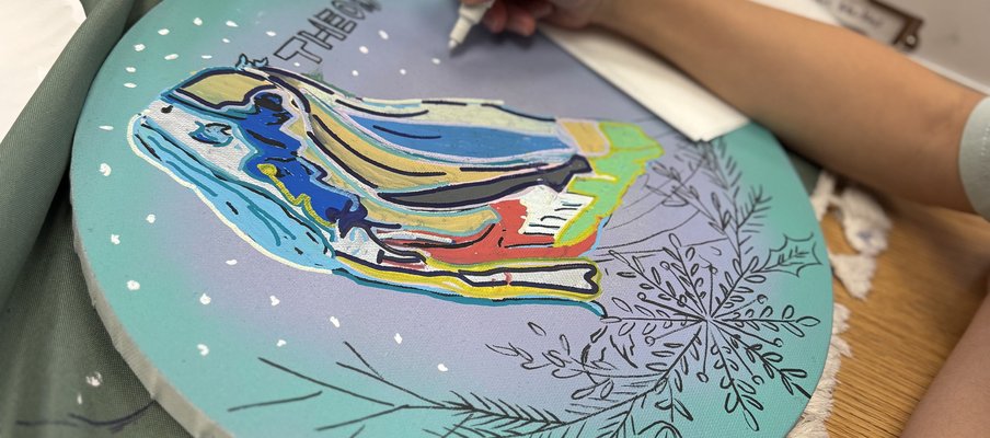 Photo of child painting a colourful art piece