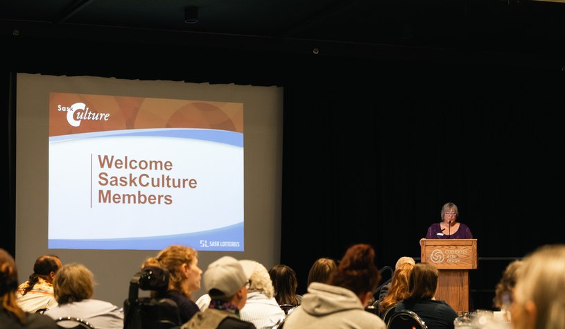 Photo of people at a previous AGM watching the presenter.