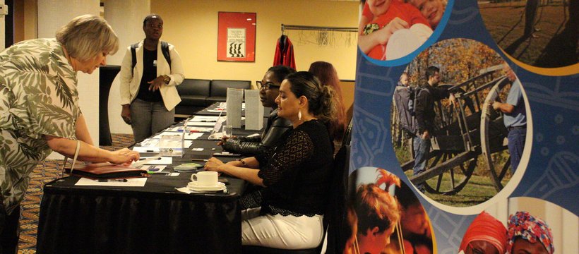 A photo of people registering at the start of the 2024 AGM.