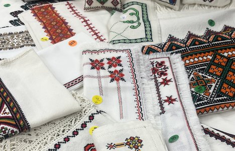 An image of various Ukrainian style embroidered items with price stickers.
