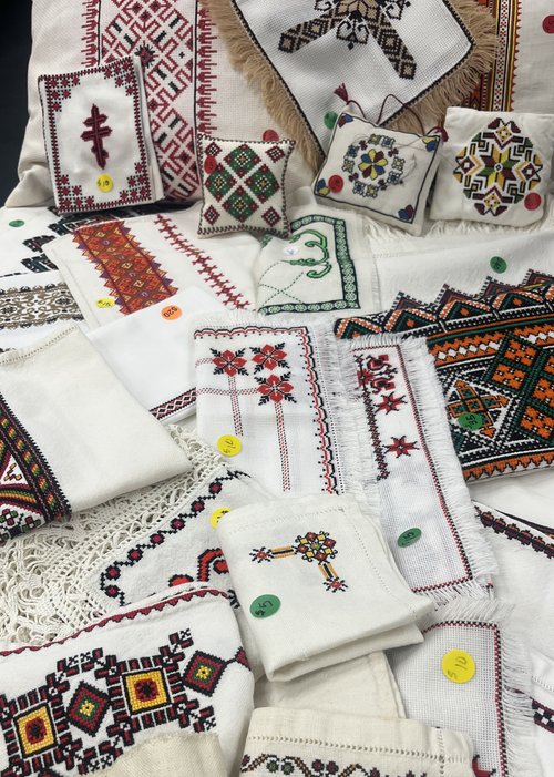 An image of various Ukrainian style embroidered items with price stickers.