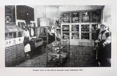 An old black and white image of a Display case at the Museum