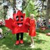 Photo of LG McIntyre and a Maple leaf mascot, Salut standing outside at Canada Day.