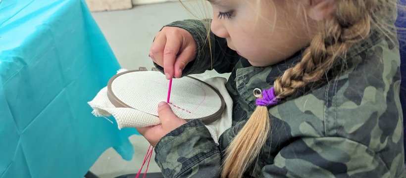 a child doing stitchwork