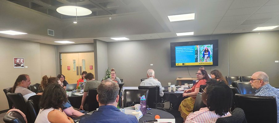 Photo of staff watching a presentation on a screen.