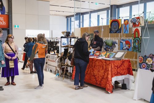 Attendees to last year's Metis Market browse booths in the atrium of Remai Modern.