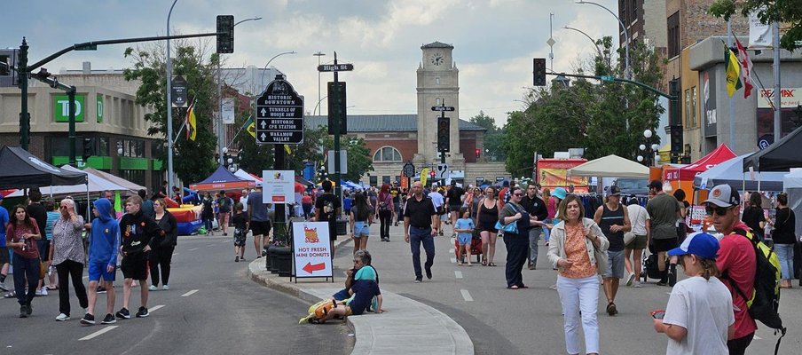 A photo of a group of people out on the streets during the Sidewalk Days 2024 event in Moose Jaw