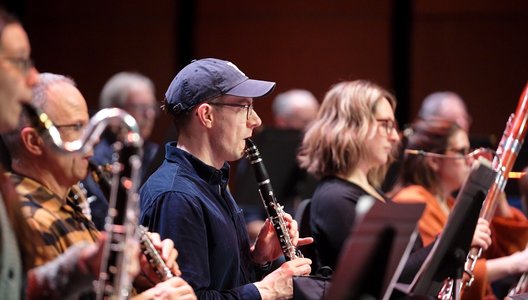 Photo of members of the orchestra playing their instruments.
