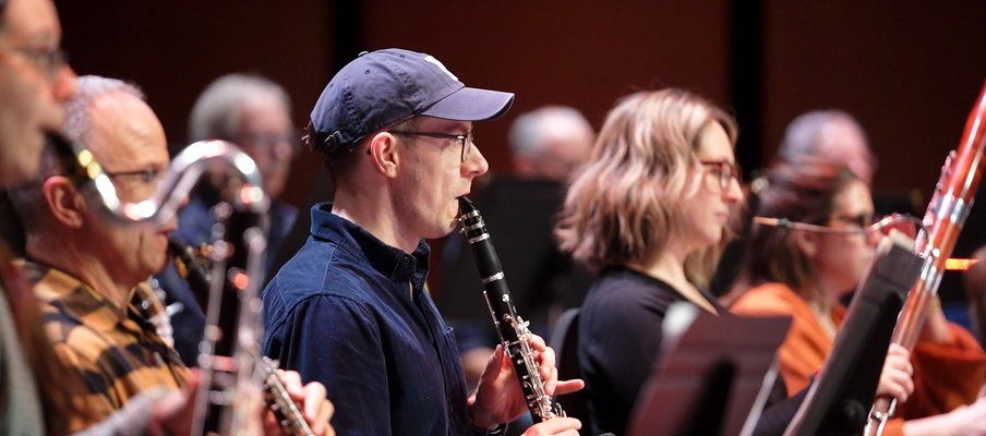Photo of members of the orchestra playing their instruments.