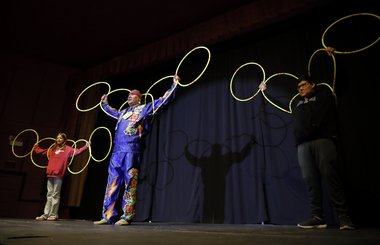Hoop dancer Terrence Littletent performing with two young people