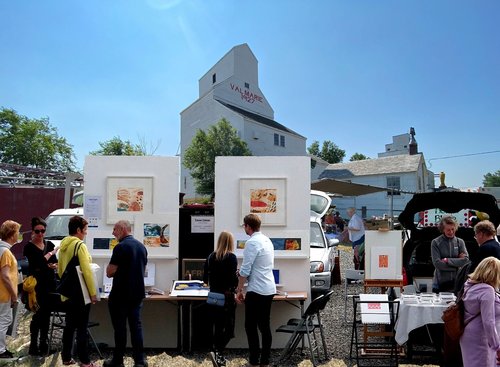 Artist concept of inaugural Tailgate Art Fair Val Marie Saskatchewan August 9 2026 showing art and craft makers and their vehicle displays in front of a heritage elevator