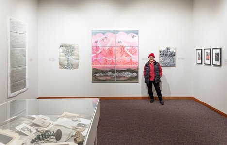 Image of Betsy Rosenwald standing next to one of her painting's titled Homage in the museum's gallery; image credit to Carey Shaw