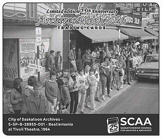 Black and white photo of people standing in a line on the sidewalk in front of stores.