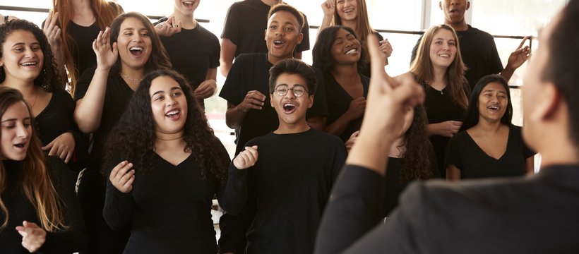 Teens in a choir singing