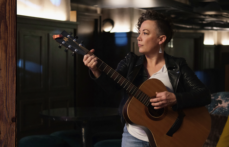 photo of Olle playing a guitar in a darkened room