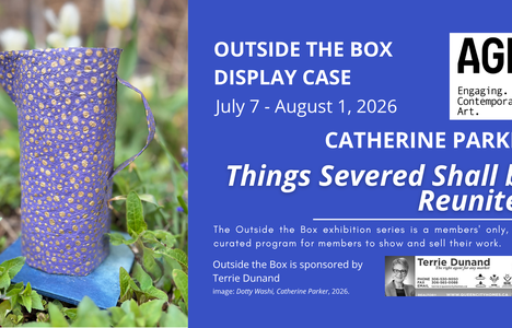 A dark blue and gold speckled paper jug stands in a flower bed