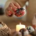 Female hand holding a pysanka egg above the candle