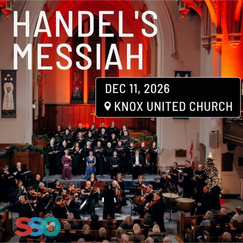 Photo of a choir and orchestra performing in a church.