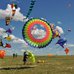 Image of many people flying multiple kites