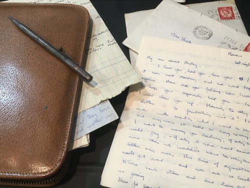 An old love letter is displayed, along with a stationery case
